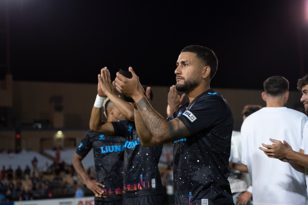 Las Vegas Lights FC forward Christian Pinzón applauding home fans after a game.